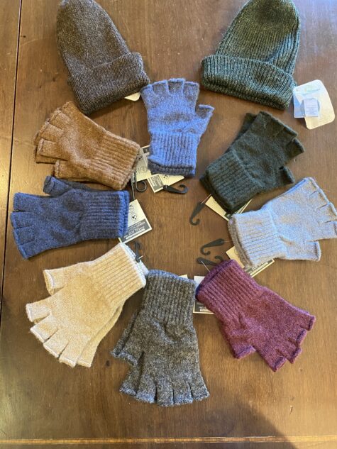 A display of fingerless Alpaca gloves and two Alpaca hats.